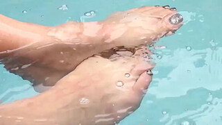 Beautiful chick with dick has solo feet play by the pool