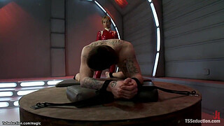 Huge boobs shemale domme in red latex Jessica Host anal fucks bound man Hayden Russo in doggy position then with big cock cums on his face and makes him cum with handjob