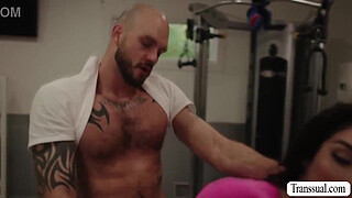 Bald guy cant stop starring at the ass of busty shemale while working out.After that,he licks her ass and barebacks it.